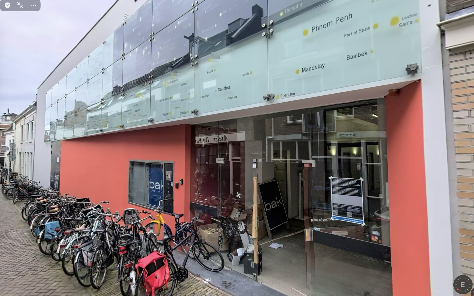 Photo of entrance of BAK Basecamp, depicting a large art gallery building with glass doors